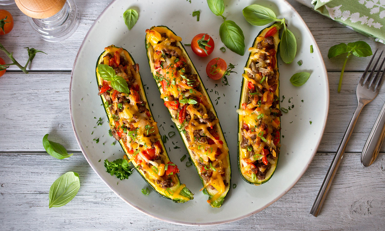 Zucchini stuffed with meat, vegetables and cheese. Zucchini boats. Loaded zucchini. overhead horizontal image